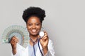 Beautiful african american female doctor holds fan of money one hundred dollar bills Royalty Free Stock Photo