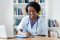 Beautiful african american female medical scientist researching for vaccines against coronavirus