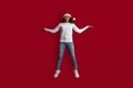 Beautiful african american female model wear santa hat jumping up Royalty Free Stock Photo