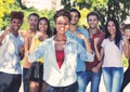 Beautiful african american female student with group of cheering young adults Royalty Free Stock Photo