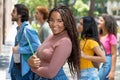 Beautiful african american female university student with group of caucasian and hispanic young adults Royalty Free Stock Photo