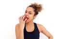 Beautiful african american girl eating apple against white background Royalty Free Stock Photo