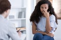 Beautiful african american girl during meeting with professional counselor Royalty Free Stock Photo