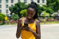 Beautiful african american girl with phone sending message Royalty Free Stock Photo