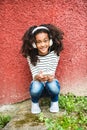 Beautiful african american girl with smart phone and earphones. Royalty Free Stock Photo