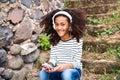 Beautiful african american girl with smart phone and earphones. Royalty Free Stock Photo
