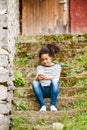 Beautiful african american girl with smart phone and earphones. Royalty Free Stock Photo