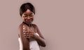 Beautiful African American Lady Applying Body Lotion On Shoulder After Bath Royalty Free Stock Photo