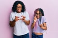 Beautiful african american mother and daughter wearing casual clothes and glasses disgusted expression, displeased and fearful Royalty Free Stock Photo