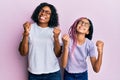 Beautiful african american mother and daughter wearing casual clothes and glasses very happy and excited doing winner gesture with Royalty Free Stock Photo