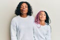 Beautiful african american mother and daughter wearing casual winter sweater looking at the camera blowing a kiss on air being Royalty Free Stock Photo