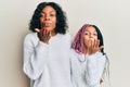 Beautiful african american mother and daughter wearing casual winter sweater looking at the camera blowing a kiss with hand on air Royalty Free Stock Photo