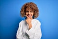 Beautiful african american sporty woman wearing casual sweatshirt over blue background looking confident at the camera smiling Royalty Free Stock Photo
