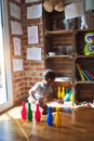 Beautiful african american toddler taking skittles to play bowling at kindergarten