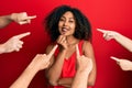 Beautiful african american woman with afro hair with fingers around pointing to herself smiling looking confident at the camera Royalty Free Stock Photo