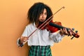 Beautiful african american woman with afro hair playing classical violin depressed and worry for distress, crying angry and afraid Royalty Free Stock Photo