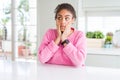 Beautiful african american woman with afro hair wearing casual pink sweater Tired hands covering face, depression and sadness,