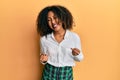 Beautiful african american woman with afro hair wearing scholar skirt very happy and excited doing winner gesture with arms Royalty Free Stock Photo