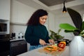 African American woman chopping vegetables in the kitchen. Woman preparing food. High quality photo Royalty Free Stock Photo
