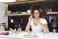 Beautiful African American woman coloring eggs