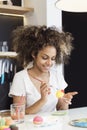 Beautiful African American woman coloring eggs Royalty Free Stock Photo