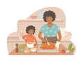 Beautiful African American woman cooks a turkey with her daughter who prepares a salad Royalty Free Stock Photo