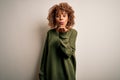 Beautiful african american woman with curly hair wearing casual sweater over white background looking at the camera blowing a kiss Royalty Free Stock Photo