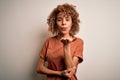 Beautiful african american woman with curly hair wearing casual t-shirt over white background looking at the camera blowing a kiss Royalty Free Stock Photo