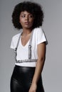 Beautiful african american woman with curly hairstyle wearing stylish clothes and leather female sword belt