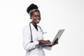 Beautiful African American woman doctor or nurse holding a laptop computer isolated on a white background Royalty Free Stock Photo
