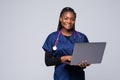 Beautiful African American woman doctor or nurse holding a laptop computer on a white background Royalty Free Stock Photo