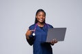 Beautiful African American woman doctor or nurse holding a laptop computer on a white background Royalty Free Stock Photo