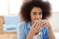 Beautiful African-American woman drinking tea at home Royalty Free Stock Photo