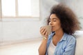 Beautiful African-American woman drinking tea at home Royalty Free Stock Photo