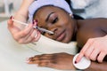 Beautiful African American woman gets injections. Cosmetology. Clinic of Aesthetic Medicine. Fillers, rejuvenation of Royalty Free Stock Photo