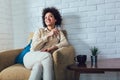 Beautiful african american woman relaxing at home, drinking wine