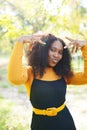 Beautiful african american woman smiling in the park during sunset. Outdoor portrait of a smiling black girl Royalty Free Stock Photo