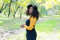 Beautiful african american woman smiling and walking in the park during sunset. Outdoor portrait of a smiling black girl Royalty Free Stock Photo