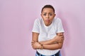 Beautiful african american woman standing over pink background shaking and freezing for winter cold with sad and shock expression Royalty Free Stock Photo