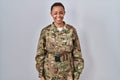 Beautiful african american woman wearing camouflage army uniform winking looking at the camera with sexy expression, cheerful and Royalty Free Stock Photo