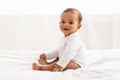 Beautiful African Baby Boy Sitting In Bed Posing In Bedroom