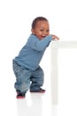 Beautiful african baby standig with a table Royalty Free Stock Photo