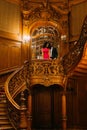 Beautiful african couple posing on the vintage stairs. Luxurious theatre interior background Royalty Free Stock Photo