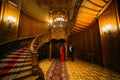 Beautiful african couple posing at the vintage stairs. Luxurious theatre interior background Royalty Free Stock Photo