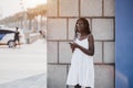 Cute black girl on the street with the cellphone