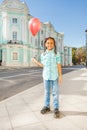Beautiful African girl with flying balloon in city Royalty Free Stock Photo