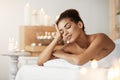 Beautiful african girl resting relaxing in spa salon with closed eyes. Royalty Free Stock Photo