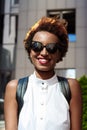 Beautiful african girl smiling walking down city. Fashion street style. Royalty Free Stock Photo