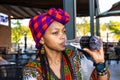 Beautiful african lady wearing a doek or headcover drinking Royalty Free Stock Photo