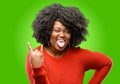 Beautiful african woman with curly hair isolated over green background